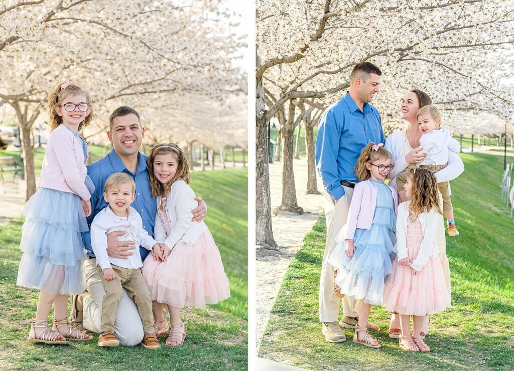 a father, mother, and their two daughters, and son smile at each other with the spring blossoms behind them on the grounds of the utah state capitol