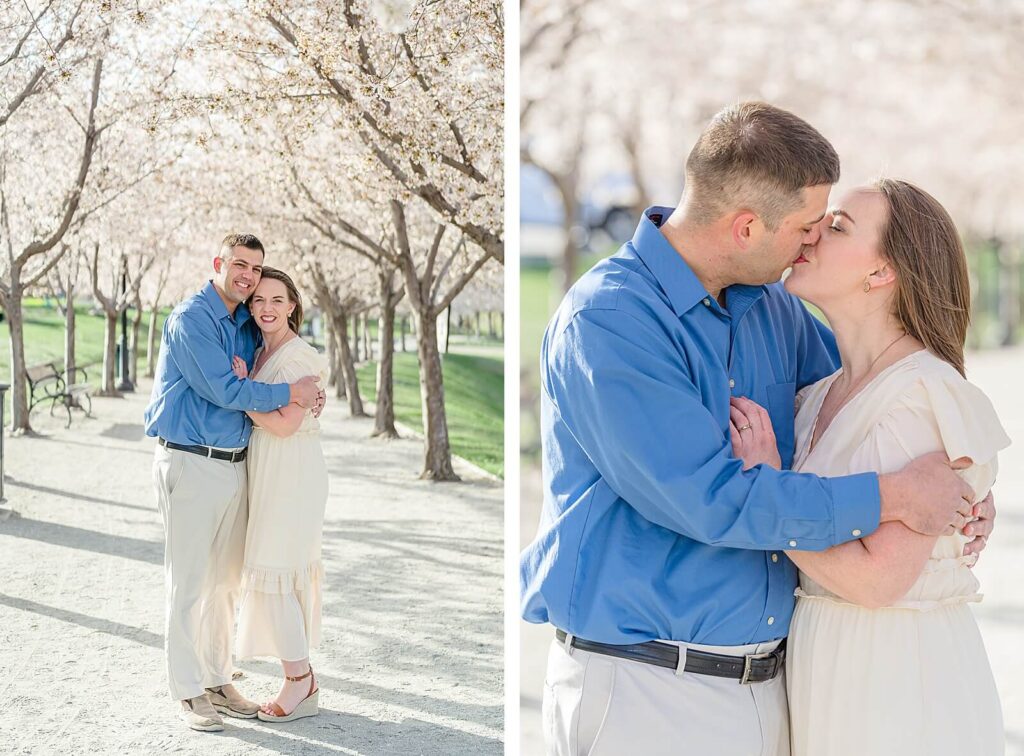 a husband wearing a cobalt blue shirt and cream colored khakis holds his wife wearing a cream colored spring dress on the grounds of the utah state capitol