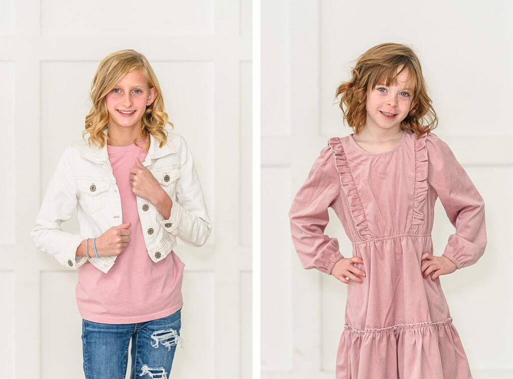 a young girl wearing a long sleeve pink dress and a teenage girl wearing blue jeans, a pink shirt, and a white denim jacket smile for their portraits at the Blank Space Studios