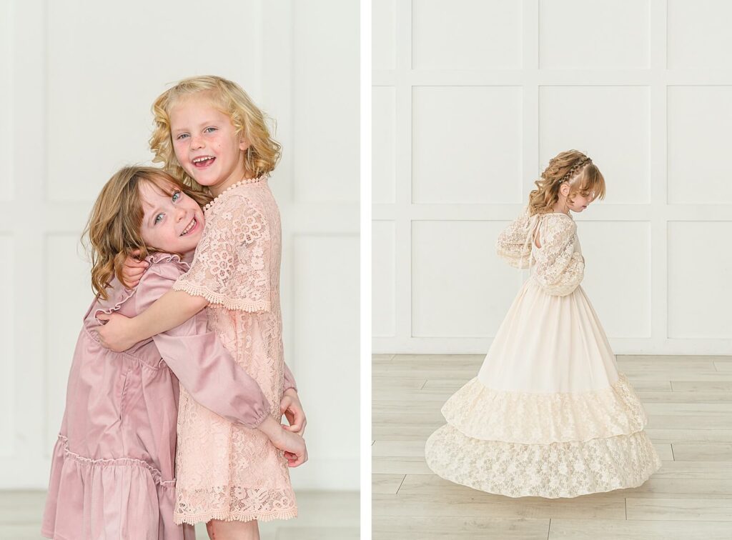 a girl in a long sleeve pink dress hugs a girl in a peach lace dress while a third girl wearing a cream colored dress spins around at The Blank Space Studios