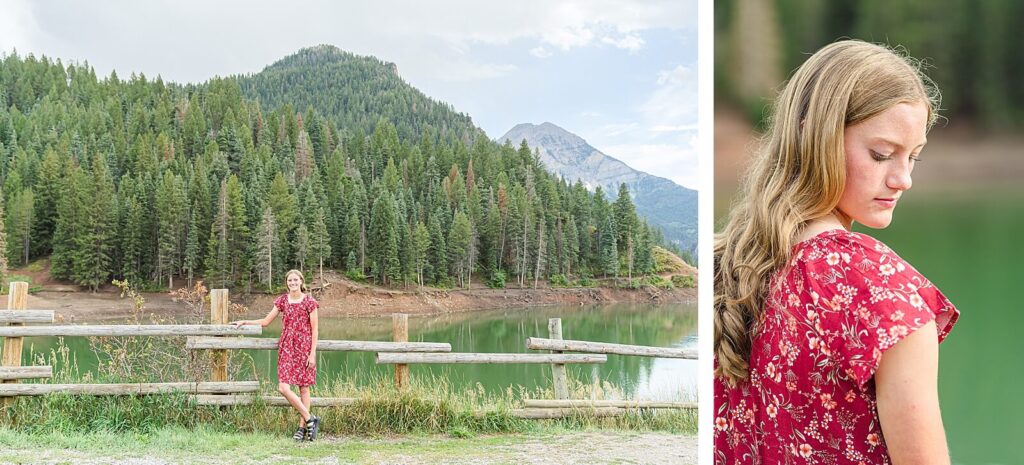 a pleasant grove high school senior girl wearing a red floral dress stands in front of a wooden fence with tibble fork reservoir in the background