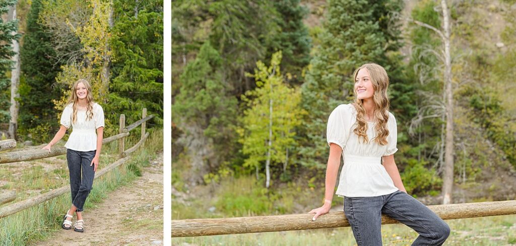a teenage girl wearing a white short sleeved blouse and black jeans sits on a fence at Tibble Fork Reservoir in American Fork