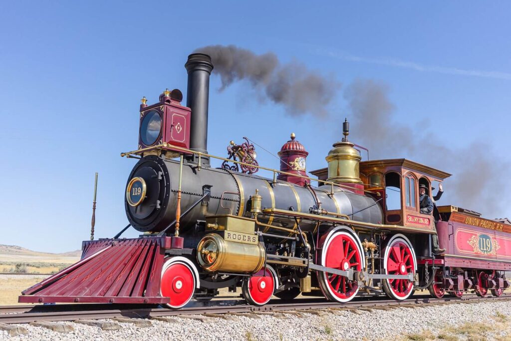 a beautiful black and red Union Pacific Railroad steam engine on wooden train tracks at Promontory Summit, Utah